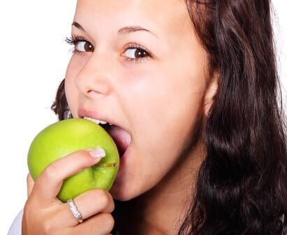 young women eating apple