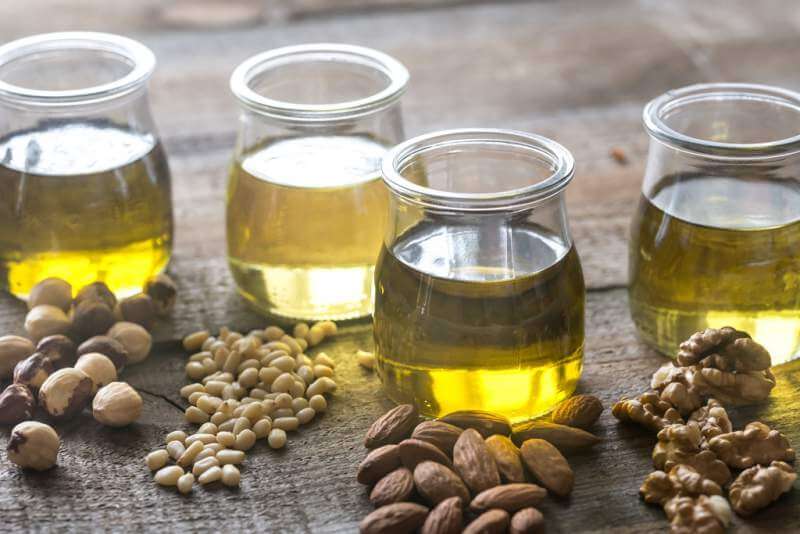 Glass jars with different kinds of nut oil