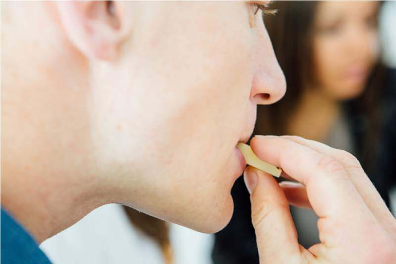 close-up-of-blur-glass-of-men-eating-cheese