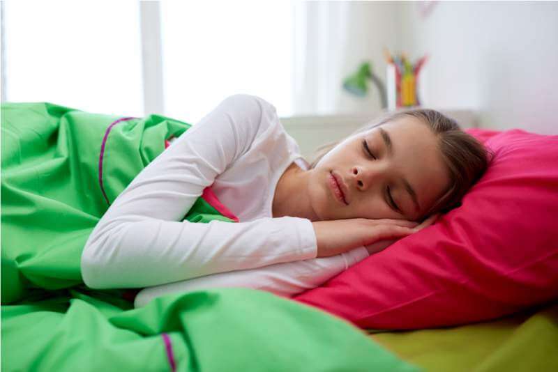 girl-sleeping-in-her-bed-at-home