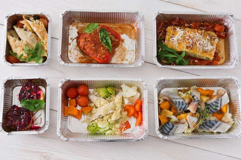 healthy-food-take-away-in-boxes-top-view-on-wood