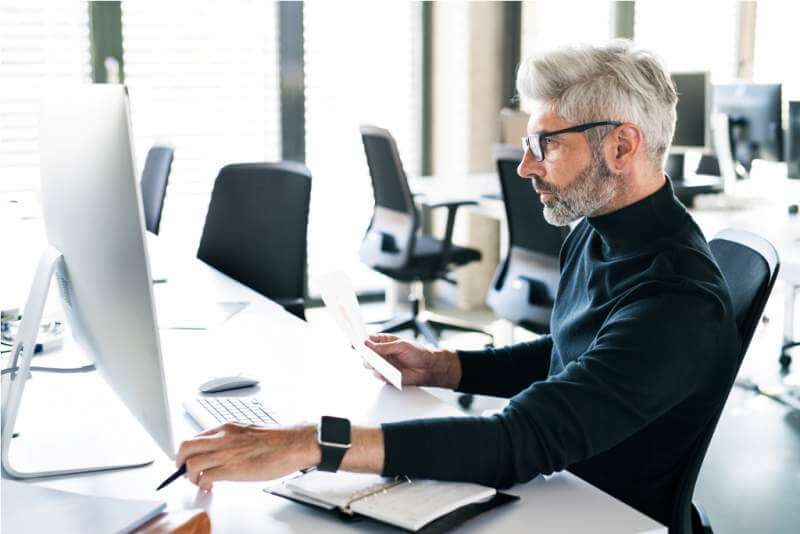 mature-businessman-with-computer-in-the-office