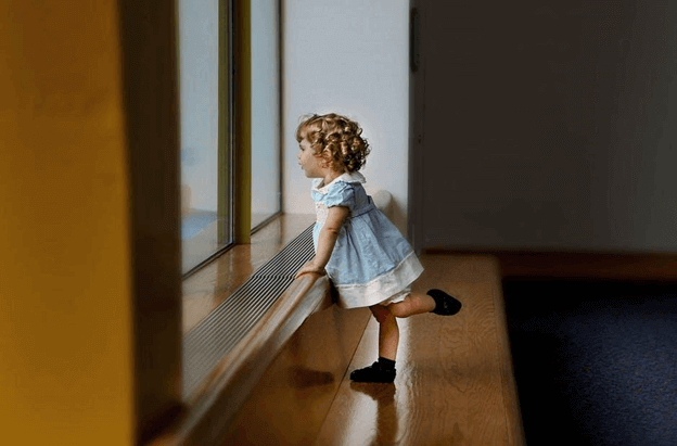 Kid infront of window