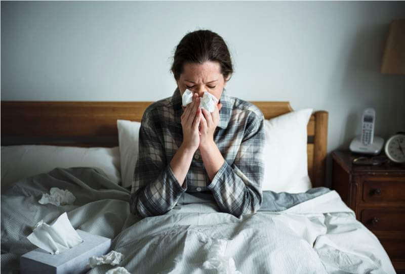 a-woman-suffering-from-flu-in-bed
