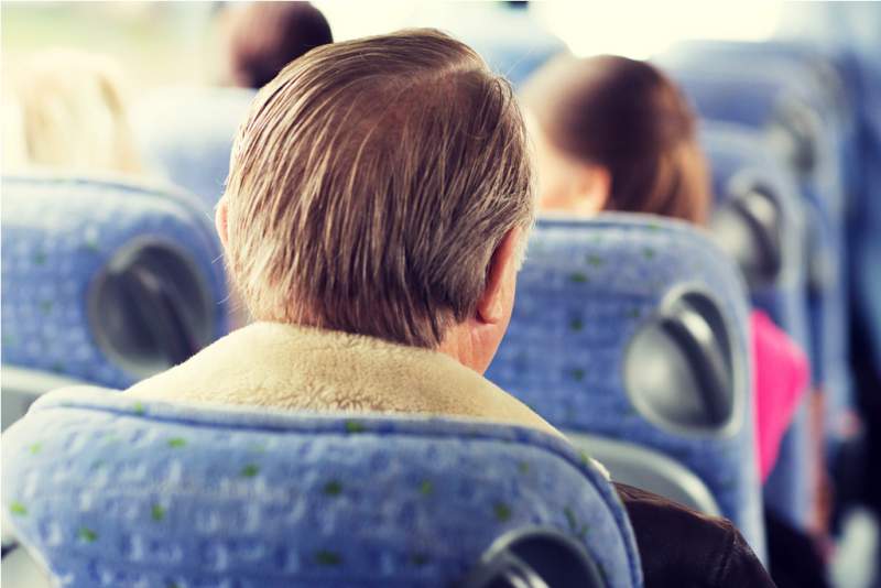 close-up-of-senior-man-sitting-in-travel-bus