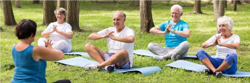 elder-people-on-yoga-class-in-the-park