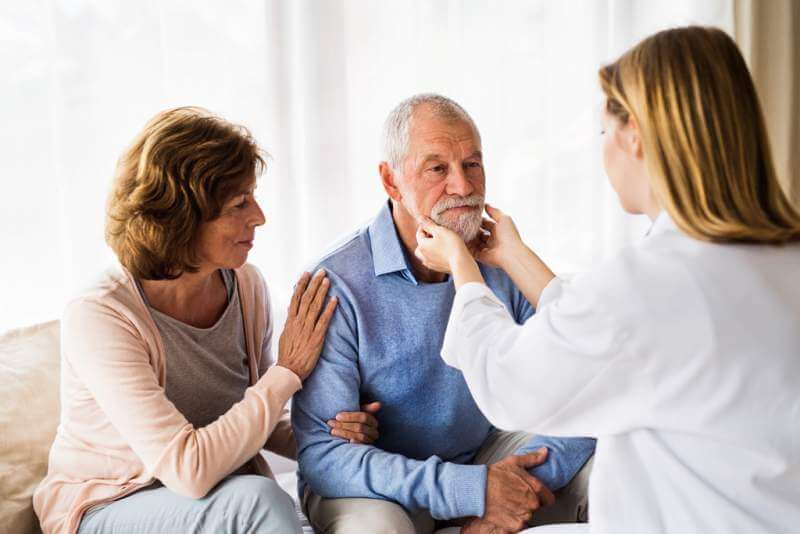 female-doctor-examining-a-senior-man