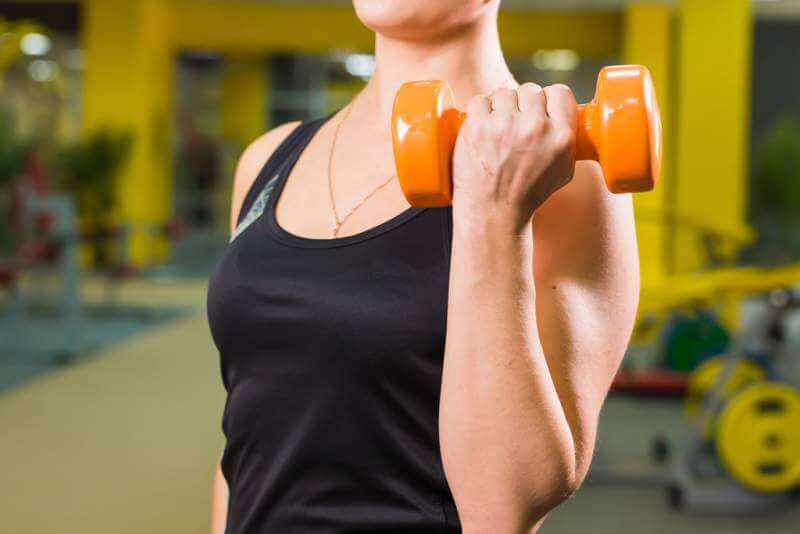 fit-girl-exercising-with-dumbbells-muscular-woman