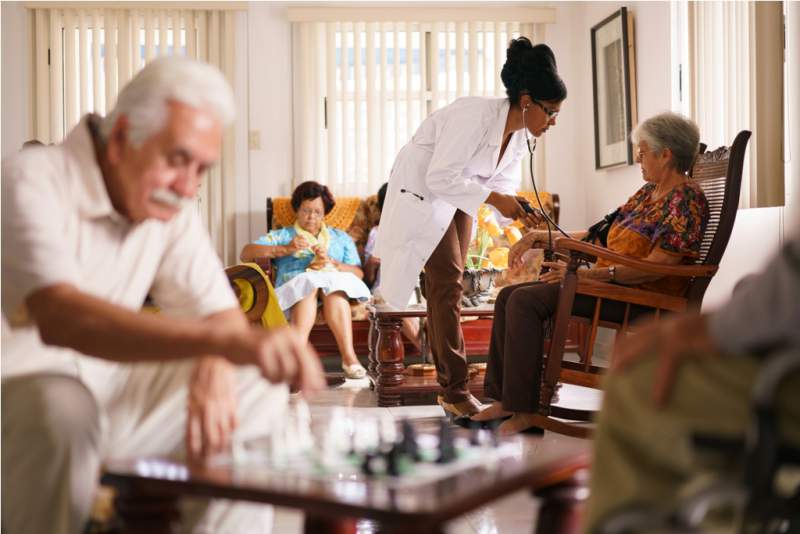 hospice-doctor-measuring-blood-pressure-to-senior