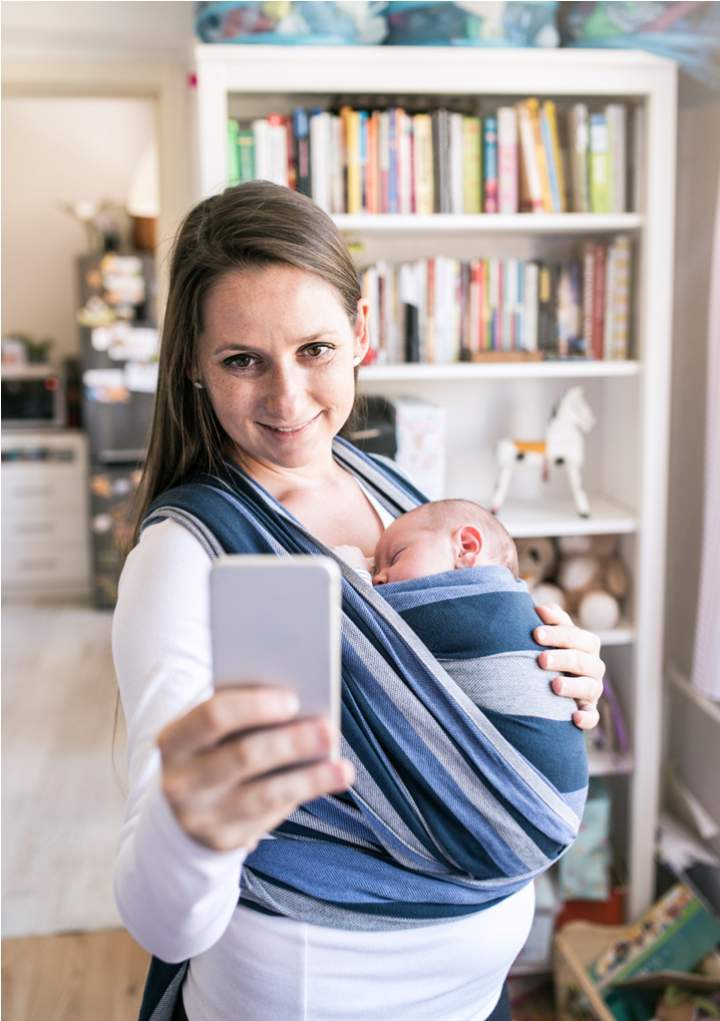 mother-with-son-in-sling-taking-selfie