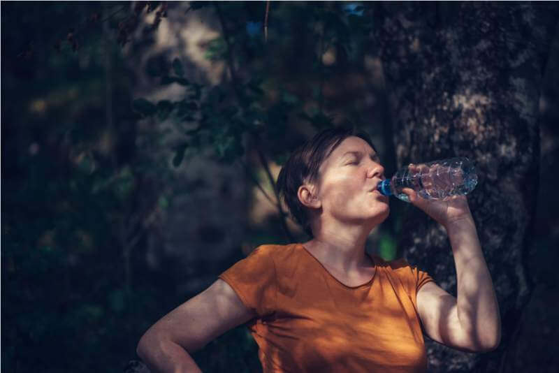 woman-drinking-water-outdoors