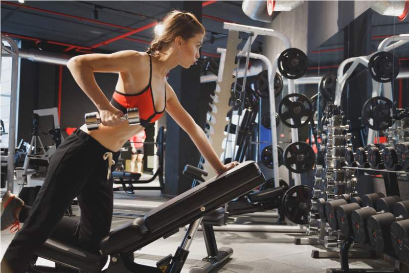 young-sports-woman-doing-exercises-with-dumbbells