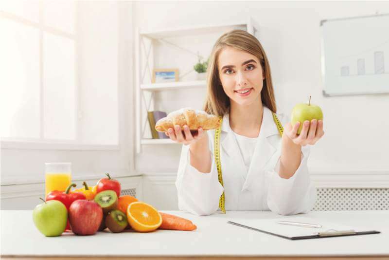 dietitian-nutritionist-with-bun-and-apple