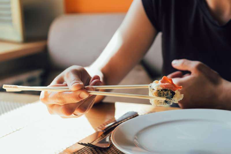 girl-eating-sushi-in-restaurant
