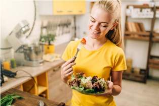 happy-woman-cooking-salad-bio-food-preparing