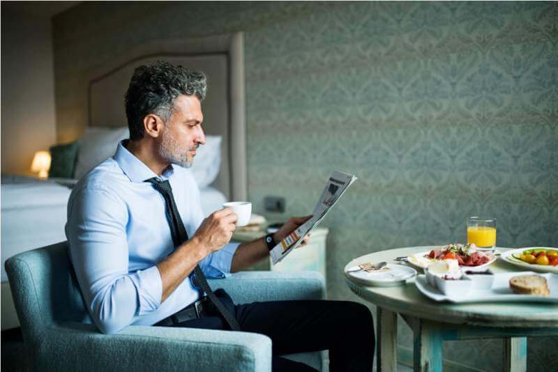 mature-businessman-having-breakfast-in-a-hotel