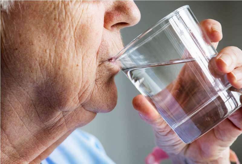 side-view-of-elderly-woman-drinking-water