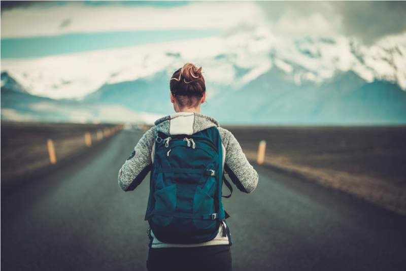 travel-hitchhiker-woman-walking-on-a-road