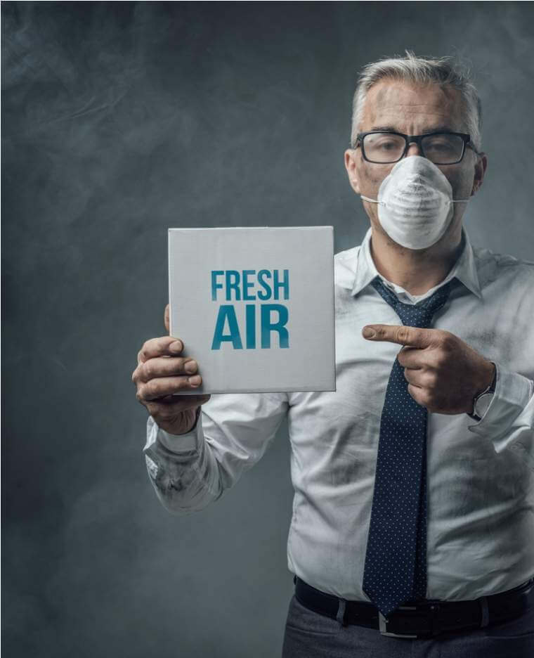 businessman-holding-a-sign-and-air-pollution