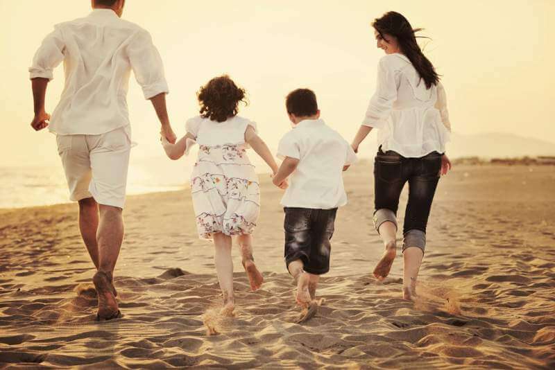 happy-young-family-have-fun-on-beach-at-sunset