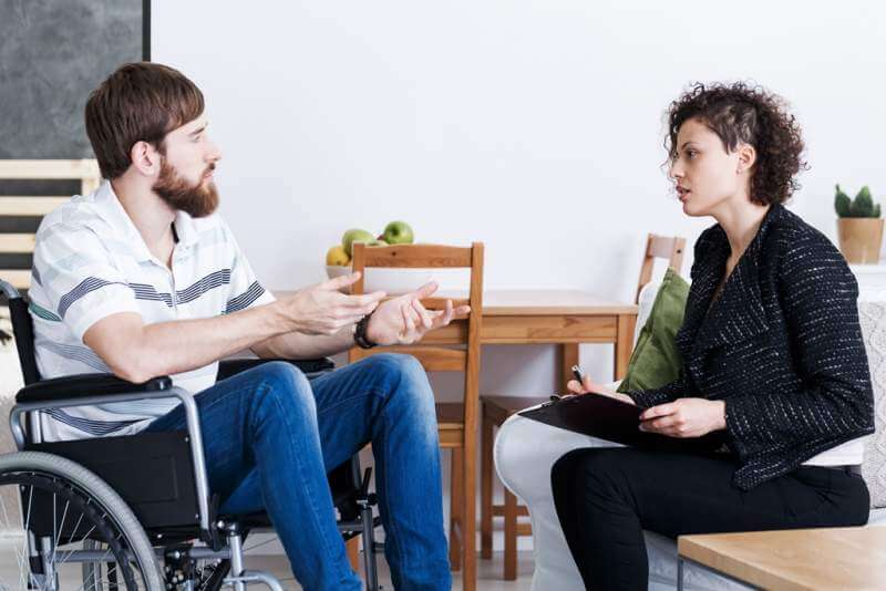 man-in-wheelchair-talking-with-psychotherapist