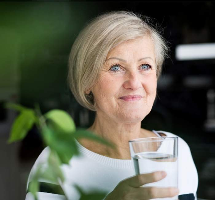 senior-woman-holding-a-glass-of-water