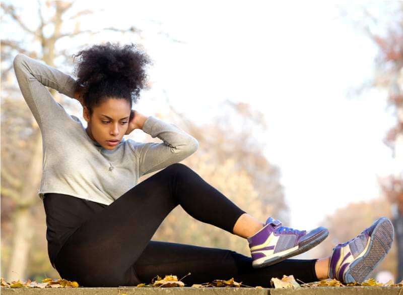 young-african-american-woman-exercising-sit-ups