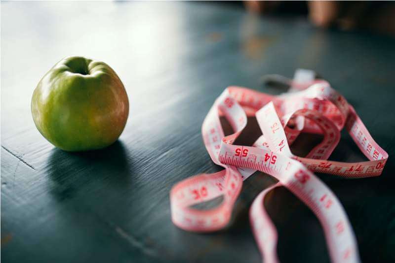 apple-and-pink-measuring-tape-weight-loss