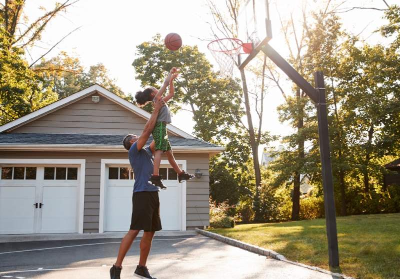 father-and-son-playing-basketball-on-driveway
