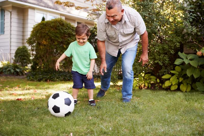 grandfather-playing-soccer-in-garden