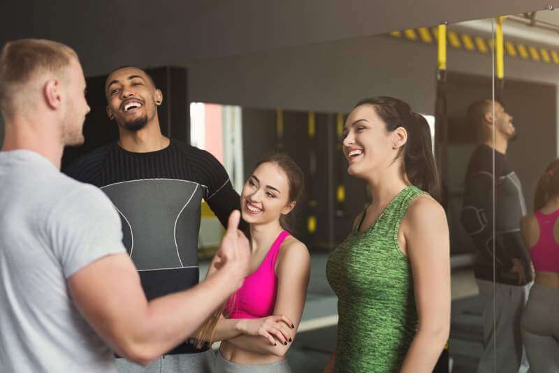 group-of-sporty-people-talking-at-gym