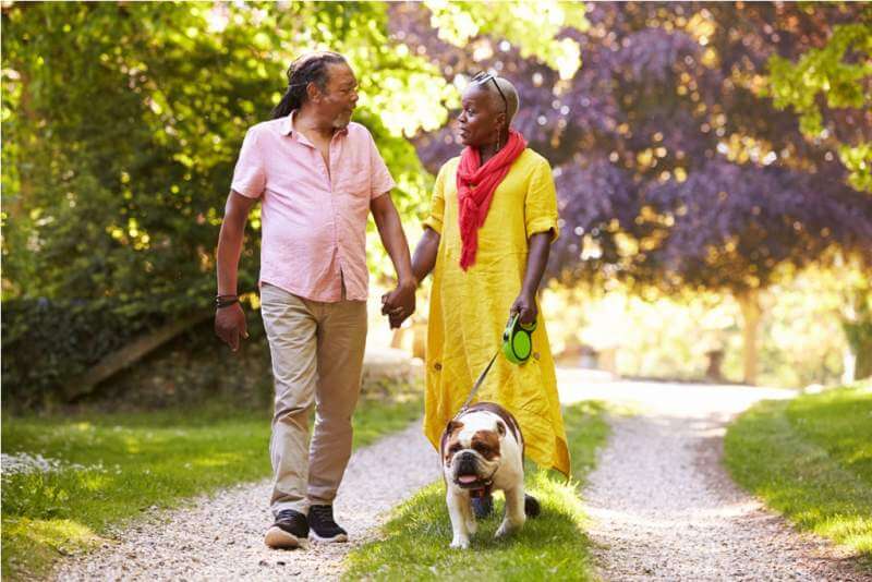 senior-couple-walking-with-pet-bulldogjpg