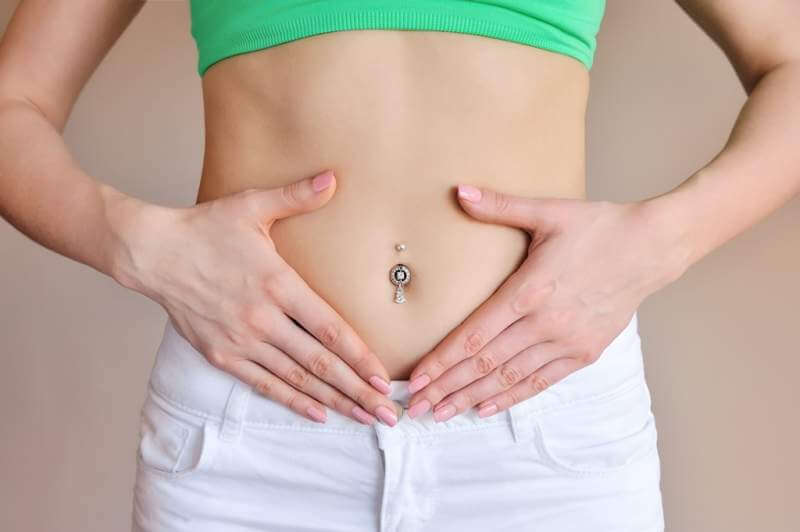 woman-holding-hands-on-a-belly-stomach-health