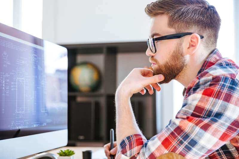 concentrated-man-in-glasses-drawing-blueprints