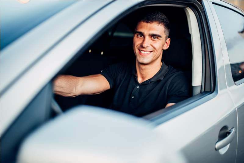 happy-male-driver-in-car-advertising