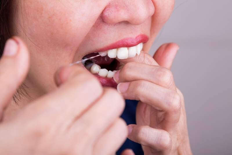 series-of-asian-woman-flossing-teeth-with-oral