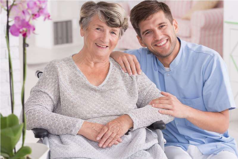 smiling-carer-with-senior-in-rest-home