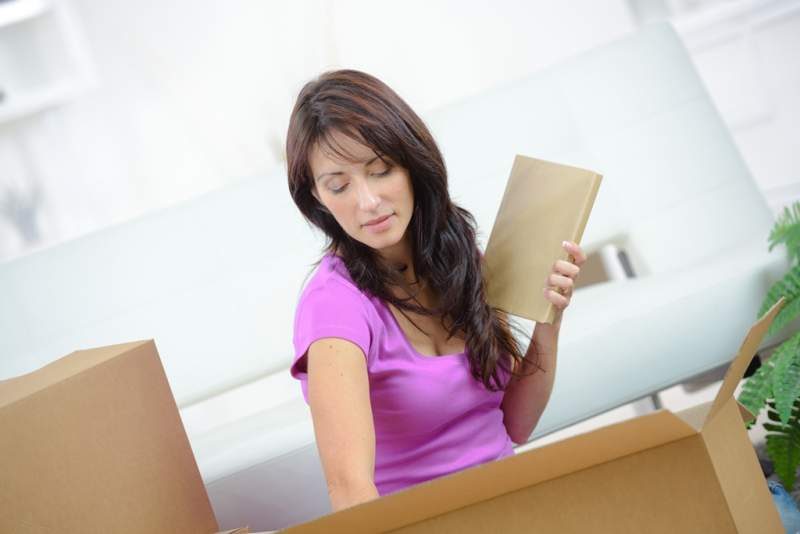 woman-unpacking-items-from-cardboard-box