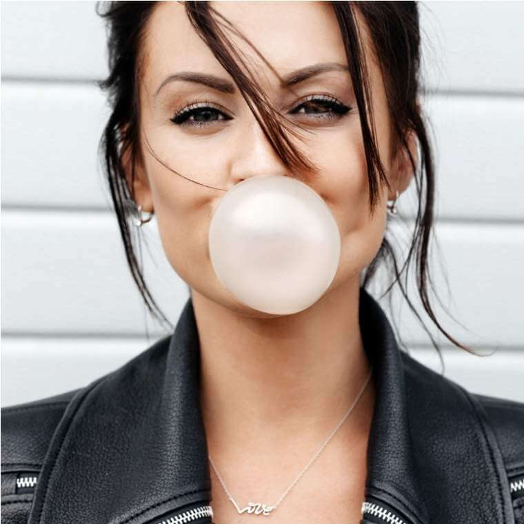 beautiful-young-woman-blowing-a-bubble-gum