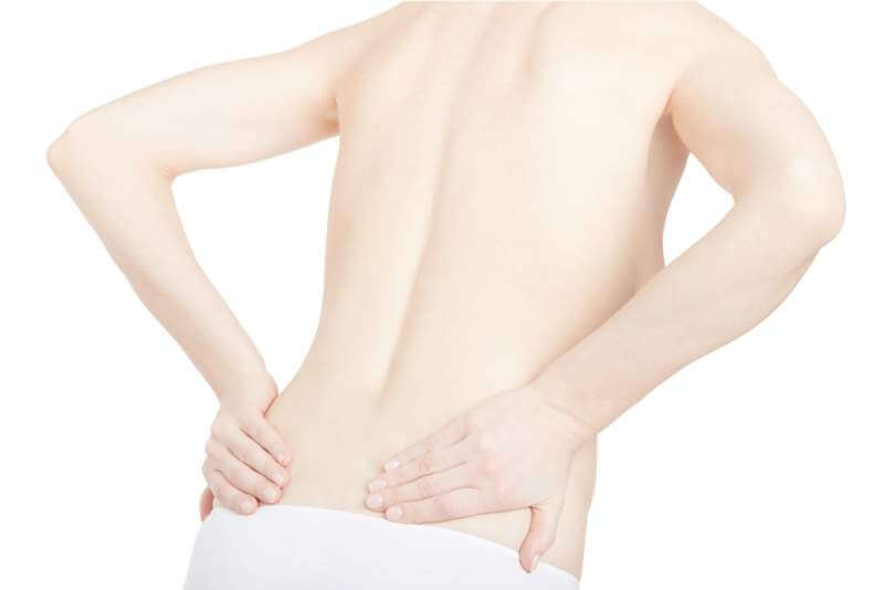 young-adult-woman-with-back-pain-isolated