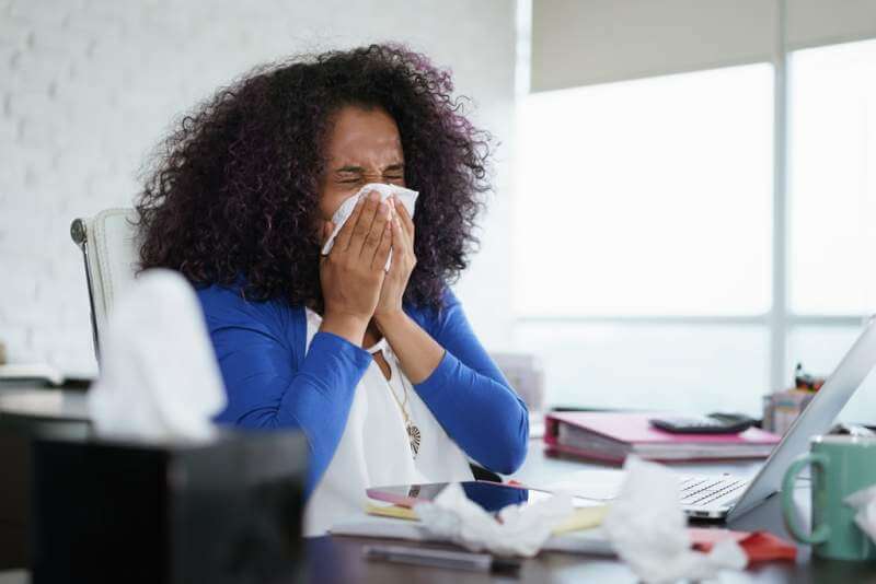 black-woman-working-from-home-and-sneezing