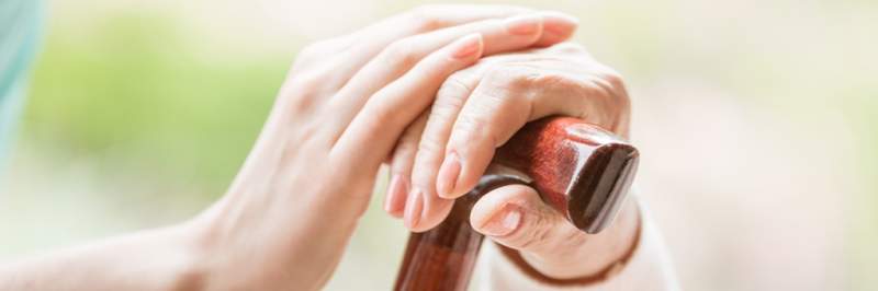 close-up-of-a-cane-with-two-womens-hands