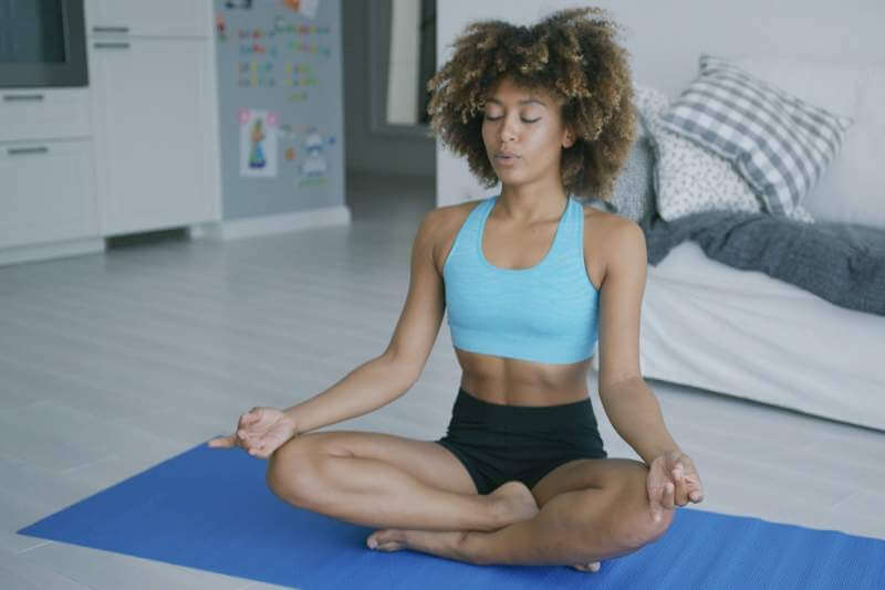 content-woman-meditating-on-mat