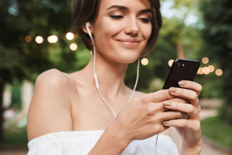 cropped-image-of-happy-young-girl-listening