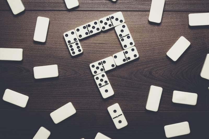 domino-pieces-forming-question-mark-on-wooden