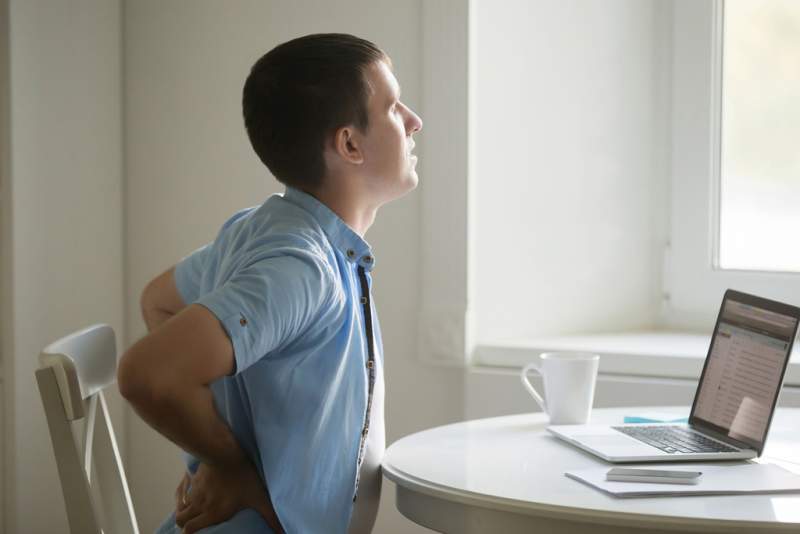 profile-portrait-of-man-at-laptop-stretching