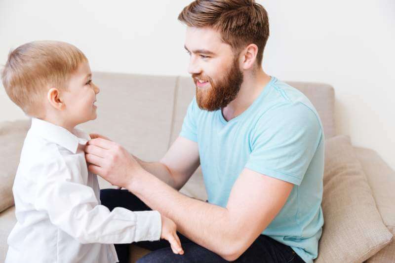 smiling-bearded-young-father-dressing