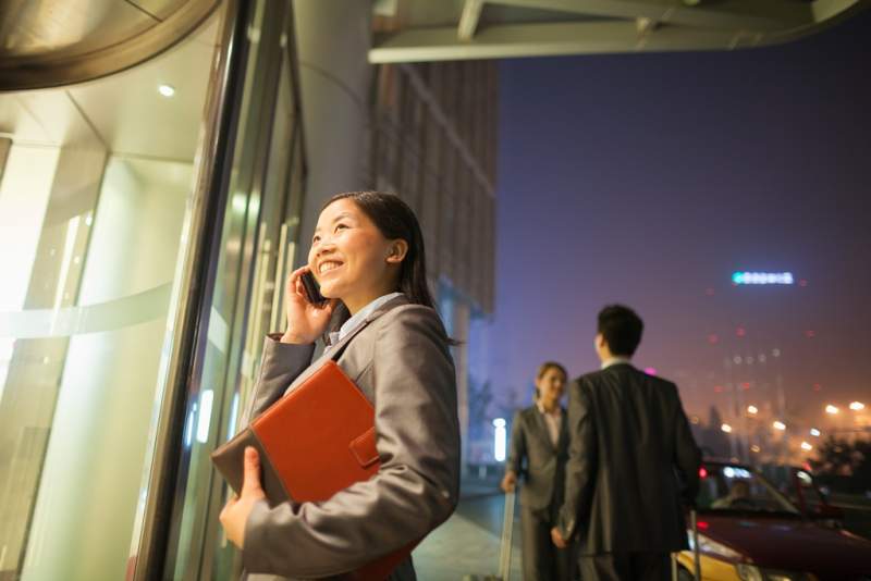 young-businesswoman-walking-and-talking-on-her