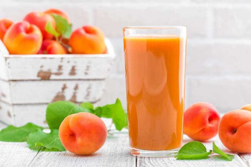 apricot-juice-and-fresh-fruits-with-leaves