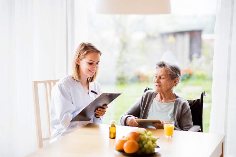 health-visitor-and-a-senior-woman-with-tablet